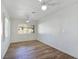 Bright bedroom with laminate flooring, a ceiling fan, and plantation shutters at 8981 Rivers Edge Dr, Las Vegas, NV 89117