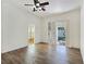 Open bedroom featuring a ceiling fan, laminate floors, an open door to the backyard, and a view of the outdoors at 8981 Rivers Edge Dr, Las Vegas, NV 89117