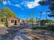 Community gatehouse entrance with meticulously manicured landscaping and desert accents at 8981 Rivers Edge Dr, Las Vegas, NV 89117