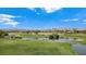 Lush golf course showcasing water features and mountain views, under a clear blue sky at 8981 Rivers Edge Dr, Las Vegas, NV 89117