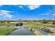 Scenic view of a lush golf course with water features and palm trees against a backdrop of mountains at 8981 Rivers Edge Dr, Las Vegas, NV 89117
