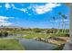 Picturesque golf course with water features, palm trees, and mountains in the background at 8981 Rivers Edge Dr, Las Vegas, NV 89117