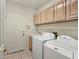 Practical laundry room with cabinets, sink, washer, and dryer for convenient chores at 8981 Rivers Edge Dr, Las Vegas, NV 89117