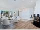 Open-concept living room featuring hardwood floors, fireplace, and plenty of natural light at 8981 Rivers Edge Dr, Las Vegas, NV 89117