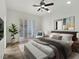 Serene main bedroom featuring a king bed, shuttered doors and natural light at 8981 Rivers Edge Dr, Las Vegas, NV 89117
