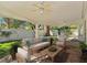 Relaxing covered patio with comfortable seating, ceiling fans and well-manicured lawn at 8981 Rivers Edge Dr, Las Vegas, NV 89117