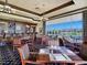 Comfortable restaurant offers a full bar, dining tables, and stunning views of the golf course at 8981 Rivers Edge Dr, Las Vegas, NV 89117