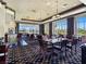 Bright restaurant featuring views of the grounds, a bar, tables, chairs, and modern lighting at 8981 Rivers Edge Dr, Las Vegas, NV 89117