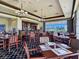 Well-lit restaurant area with a bar, multiple tables, and a picturesque view of the community at 8981 Rivers Edge Dr, Las Vegas, NV 89117