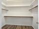 Spacious walk-in closet with wooden rods and shelves for optimal organization at 8981 Rivers Edge Dr, Las Vegas, NV 89117
