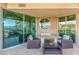 Spacious covered balcony with large doors, city and mountain views and stone walls at 9101 Alta Dr # 203, Las Vegas, NV 89145