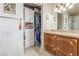 Open walk-in closet with drawers and shelves leading into a bathroom with a marble vanity at 9101 Alta Dr # 203, Las Vegas, NV 89145