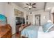 Comfortable bedroom featuring wood floors, ceiling fan, and flat screen TV at 9101 Alta Dr # 203, Las Vegas, NV 89145
