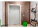 Private elevator access with mosaic tile walls and interesting art sculptures at 9101 Alta Dr # 203, Las Vegas, NV 89145