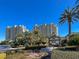 Luxurious high-rise condominium complex with lush landscaping and signage for One Queensridge Place at 9101 Alta Dr # 203, Las Vegas, NV 89145