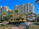 Luxurious high-rise condominium complex with lush landscaping and signage for One Queensridge Place at 9101 Alta Dr # 203, Las Vegas, NV 89145