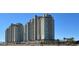 Two luxurious high-rise condominiums with desert landscaping, and clear blue sky at 9101 Alta Dr # 203, Las Vegas, NV 89145