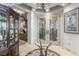 Gracious entry foyer features marble floors, glass table, and double etched glass doors at 9101 Alta Dr # 203, Las Vegas, NV 89145