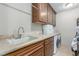 Laundry room with white appliances, sink, counter space and storage cabinets at 9101 Alta Dr # 203, Las Vegas, NV 89145