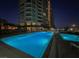 Resort-style swimming pool with city views at night at 9101 Alta Dr # 203, Las Vegas, NV 89145