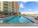 Large pool area is perfect for relaxing with many lounge chairs and umbrellas for shade in the sun at 9101 Alta Dr # 203, Las Vegas, NV 89145