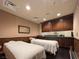A tranquil spa room with two massage tables, cabinetry, and soothing decor at 9101 Alta Dr # 203, Las Vegas, NV 89145