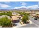 Aerial view of the landscaped backyard, home, neighborhood, and surrounding mountains at 913 Hickory Park St, Las Vegas, NV 89138