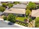 Aerial view of the fenced backyard, covered patio, home, and lush landscaping at 913 Hickory Park St, Las Vegas, NV 89138