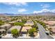 Stunning aerial view of a desert community nestled beneath majestic mountains and clear skies at 913 Hickory Park St, Las Vegas, NV 89138