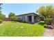 Backyard view of the covered patio, lush grass, and mature trees at 913 Hickory Park St, Las Vegas, NV 89138