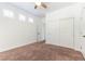 Neutral bedroom with a ceiling fan, windows with shutters, and double door closet at 913 Hickory Park St, Las Vegas, NV 89138