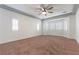 Spacious bedroom with plush carpet, tray ceiling, and large windows at 913 Hickory Park St, Las Vegas, NV 89138