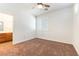 Sunlit bedroom featuring a ceiling fan, window with shutters, and neutral carpet at 913 Hickory Park St, Las Vegas, NV 89138