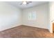 Simple, carpeted bedroom with natural light and a ceiling fan at 913 Hickory Park St, Las Vegas, NV 89138