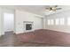 Bright living room with fireplace, ceiling fan, and plantation shutters at 913 Hickory Park St, Las Vegas, NV 89138