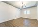 Bright, open living room featuring hardwood floors, fresh paint, and a contemporary light fixture at 913 Hickory Park St, Las Vegas, NV 89138