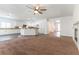 Open-concept living room seamlessly transitions to the kitchen with granite countertops and white cabinetry at 913 Hickory Park St, Las Vegas, NV 89138