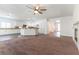 Open-concept living room and kitchen with white cabinets and granite countertops at 913 Hickory Park St, Las Vegas, NV 89138