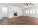 Spacious living area with a fireplace, plantation shutters, and mixed flooring at 913 Hickory Park St, Las Vegas, NV 89138