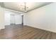 Bright, open living room with hardwood floors, fresh paint, and a modern light fixture at 913 Hickory Park St, Las Vegas, NV 89138