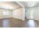 Bright, open living room with new flooring, fresh paint, and a modern light fixture at 913 Hickory Park St, Las Vegas, NV 89138