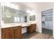 Main bathroom with double vanity, a large mirror, and walk-in closet access at 913 Hickory Park St, Las Vegas, NV 89138