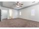 Bright main bedroom featuring a ceiling fan, tray ceiling, and an ensuite bathroom at 913 Hickory Park St, Las Vegas, NV 89138