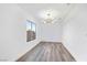 Bright dining room with modern light fixture and wood-look flooring at 9541 Summersweet Ct, Las Vegas, NV 89123