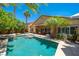 Backyard pool with mature landscaping, covered patio, and ample seating under the bright blue skies at , Las Vegas, NV 89113