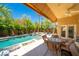 Charming outdoor patio with a pool, beautiful greenery, and dining set for entertaining at , Las Vegas, NV 89113