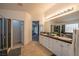 Bright bathroom with double sinks, granite countertops, tiled floors and a glass shower at , Las Vegas, NV 89113