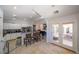 Bright kitchen featuring white cabinetry, stainless steel appliances, and breakfast bar with backyard access at , Las Vegas, NV 89113
