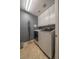 Efficient laundry room with gray walls, white cabinets, and modern washer and dryer set at , Las Vegas, NV 89113