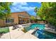 Backyard featuring a private pool, covered patio with outdoor seating, and lush landscaping at , Las Vegas, NV 89113